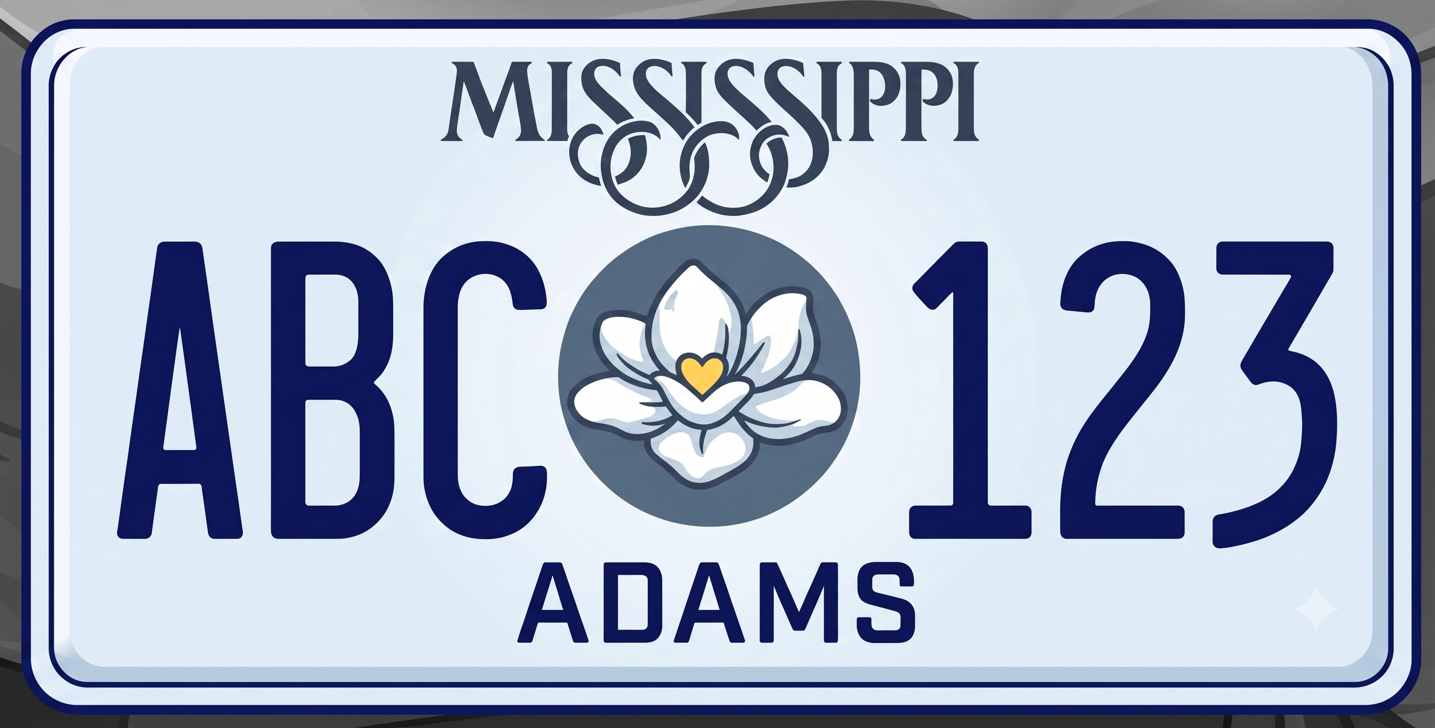 Mississippi current license plate: pale blue background with a dark navy border, MISSISSIPPI in large dark navy letters at the top with an ornate script flourish of interlocking loops below, a center medallion showing a white magnolia bloom with a gold heart center on a slate-gray circular background, large bold navy ABC on the left and 123 on the right, and ADAMS county name in dark navy at the bottom